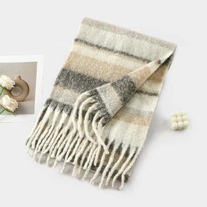 Detailed view of cozy winter striped cashmere scarf with elegant fringe and soft texture.