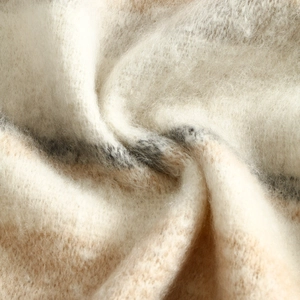 Soft cashmere-like scarf fabric detail, cozy striped texture macro shot for winter warmth.