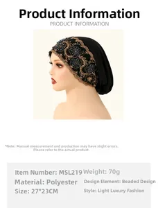 Close-up of black polyester turban featuring gold floral lace and blue beaded details