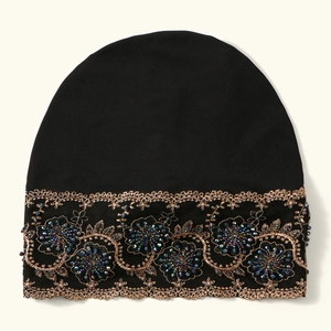 Black turban hat with intricate gold flower embroidery and colorful beaded embellishments
