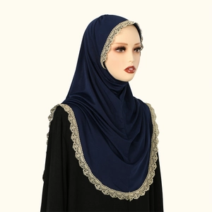 Detailed view of navy blue chiffon hijab with elegant golden floral lace border