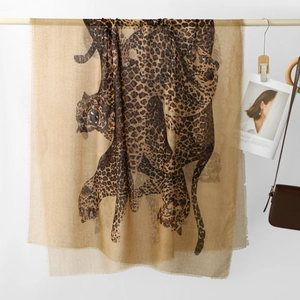 Detailed view of lightweight leopard print shawl with fringe edges and silky texture