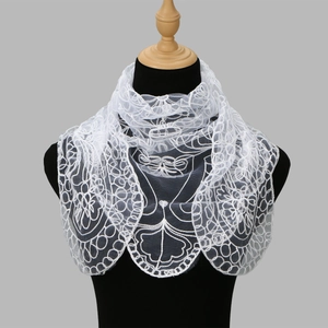 Detailed view of delicate white floral lace embroidery on sheer mesh headscarf