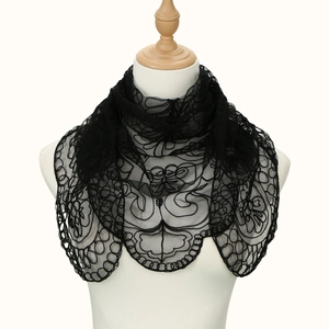 Close-up of elegant black lace embroidery on semi-transparent bridal veil wrap