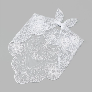 Detailed view of white floral lace headscarf with intricate embroidery and scalloped edges