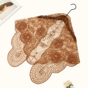 Detailed macro view of brown lace embroidery shawl with vintage floral mesh pattern