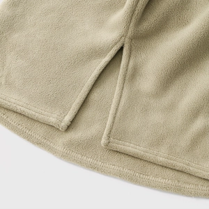 Close-up of khaki fleece hoodie hem featuring side slits and double-needle stitching