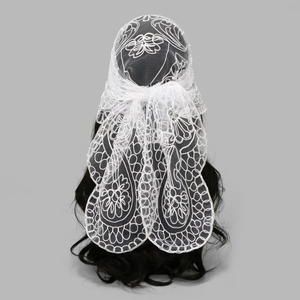 White lace headscarf with floral embroidery on a mannequin in a minimalist style