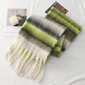 Detail of soft thick striped scarf featuring neon yellow color block and long tassels