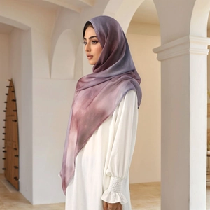 Detailed drape of gradient purple chiffon hijab worn with a white abaya in elegant setting