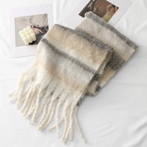 Close-up of thick striped winter scarf with plush fringe details and soft mohair texture