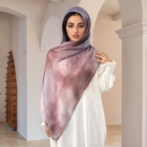 Detail of purple gradient tie-dye hijab showing soft fabric texture and elegant drape