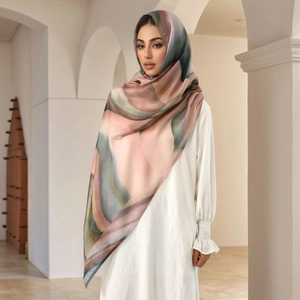 Detail of soft abstract print headscarf with silky texture in earthy neutral tones