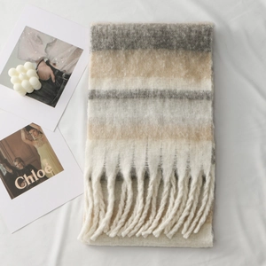 Close-up of thick multi-color striped scarf with soft fringe and plush texture detail