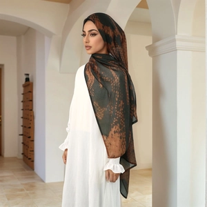 Close-up of Turkish style rayon headscarf with bronze abstract print on chiffon fabric