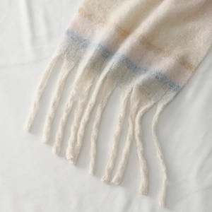Chunky knit colorblock scarf with soft tassels and pastel stripes for winter warmth