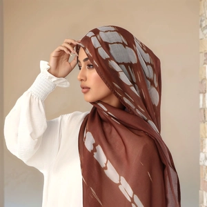Detail of soft rayon headscarf for women featuring dark brown ethnic tie-dye patterns