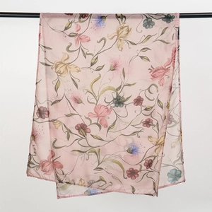Detail of light pink floral viscose headscarf with hand-painted flower and vine patterns