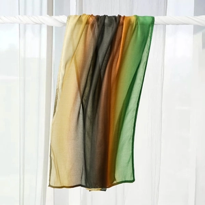 Detailed close-up of gradient cotton headscarf shawl hanging with natural lighting