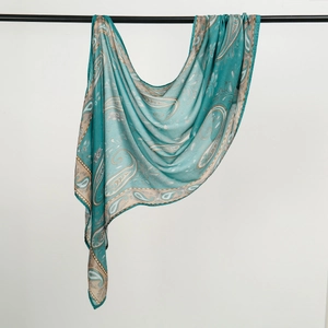 Detail of teal rayon headscarf showing intricate paisley print and soft silky texture