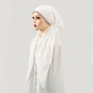Detail of white cotton linen hijab featuring champagne rhinestones and soft draped texture