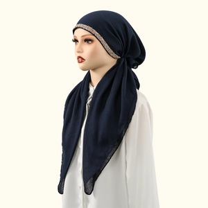 Detail of navy blue cotton hijab featuring gold sequin trim and breathable soft fabric