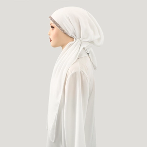 Detail of white cotton linen hijab featuring sparkling rhinestone headband and soft texture