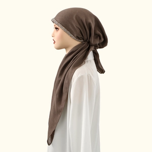 Detail of dark coffee cotton hijab with sparkling rhinestone trim on the forehead band