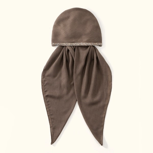 Close-up of brown cotton linen headscarf featuring sparkling rhinestone details and soft fabric