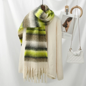 Detail view of thick neon green and grey striped scarf with soft fringe and knit texture