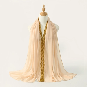 Detail of elegant champagne chiffon scarf with golden floral lace and sequins