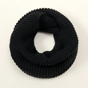 Close-up of thick black knitted texture on warm winter infinity snood scarf