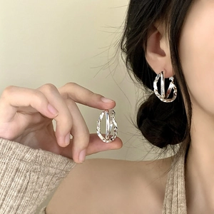 Elegant silver twisted triple hoop earrings featuring a minimalist crossover design for women