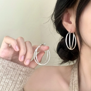 Minimalist silver interlocking triple-hoop earrings with textured sandblasted finish
