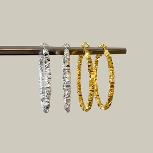 Chic geometric irregular hoop earrings in gold and silver with faceted metal texture