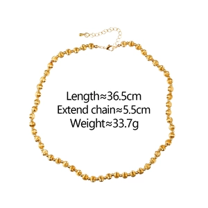 Detail of gold metal ball necklace showing lobster clasp and adjustable extension chain