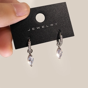 Silver marquise-cut zircon drop earrings with pavé accents on a jewelry card