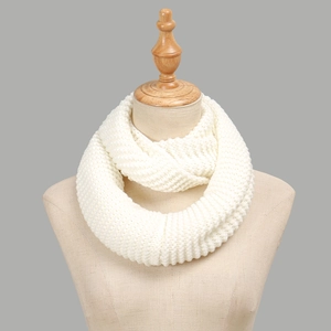 Chunky knit infinity scarf in cream ivory displayed on a neutral model torso