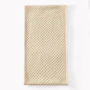 Detail of off-white corn knit pattern on a winter neck warmer with hollow texture