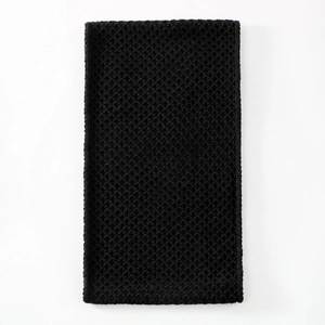 Close-up of black waffle knit neck warmer with thick corn stitch texture for winter