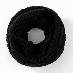Detail shot of black chunky knit infinity scarf featuring honeycomb texture and warm thick yarn