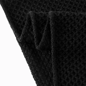 Close-up of black waffle knit texture on a thick winter infinity scarf for men and women