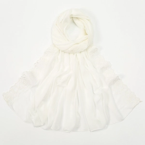 Detailed close-up of rose flower embroidery on semi-transparent white chiffon scarf fabric