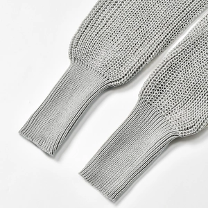 Detailed view of light gray knit cardigan featuring ribbed cuffs and open mesh weave