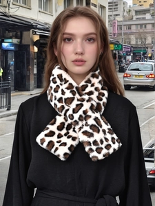 Detail of soft leopard print faux fur scarf featuring a stylish criss-cross design