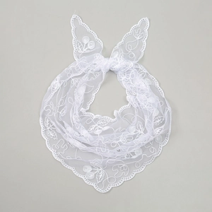 Detail of white lace triangle scarf featuring cherry embroidery and floral mesh texture