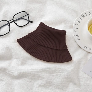 Detailed view of dark brown knitted turtleneck neck warmer with elastic ribbed texture