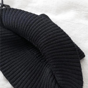 Detailed close-up showing the soft ribbed knit texture of this black winter neck warmer snood.