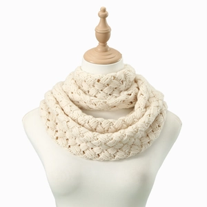 Close-up detail of the chunky cable knit texture on this cream white winter neck warmer