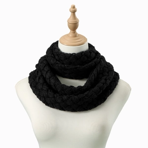 Detailed close-up of thick cable knit pattern on black chunky infinity scarf